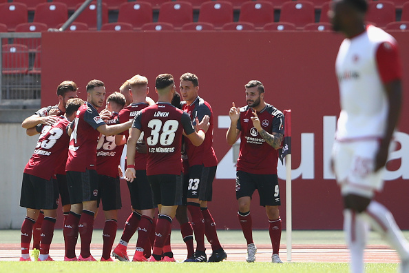 NUREMBERG, GERMANY - JULY 30:  Hanno Behrens (covered) of Nuernberg celebrates his team's first goal with team mates during the Second Bundesliga match between 1. FC Nuernberg and 1. FC Kaiserslautern at Max-Morlock-Stadion on July 30, 2017 in Nuremberg, Germany.  (Photo by Alex Grimm/Bongarts/Getty Images)