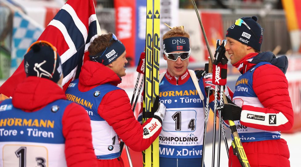 RUHPOLDING, GERMANY - JANUARY 12:  Johannes Thingnes Boe (C) of Norway celebrates victory with his team mates at the finish area after the men's 7,5km relay competition during the IBU Biathlon World Cup at Chiemgau Arena on January 12, 2018 in Ruhpolding, Germany.  (Photo by Alexander Hassenstein/Bongarts/Getty Images)