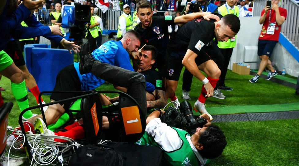 MOSCOW, RUSSIA - JULY 11:  Croatia players knock over a photographer as they celebrate after Mario Mandzukic of Croatia scores their team's second goal during the 2018 FIFA World Cup Russia Semi Final match between England and Croatia at Luzhniki Stadium on July 11, 2018 in Moscow, Russia.  (Photo by Dan Mullan/Getty Images)