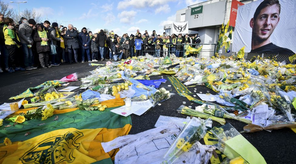 FC Nantes supporters gather in front of a portrait of late Argentinian forward Emiliano Sala to pay tribute prior to the French L1 football match between FC Nantes and Nimes Olympique at the La Beaujoire stadium in Nantes, western France on February 10, 2019. - FC Nantes football club announced on February 8, 2019 that it will freeze the #9 jersey as a tribute to Cardiff City and former Nantes footballer Emiliano Sala who died in a plane crash in the English Channel on January 21, 2019. (Photo by LOIC VENANCE / AFP)        (Photo credit should read LOIC VENANCE/AFP/Getty Images)