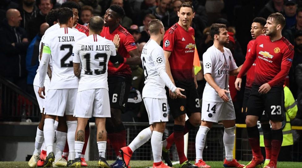 Manchester United's French midfielder Paul Pogba (5R) reacts as he remonstrates with Paris Saint-Germain's Brazilian defender Dani Alves (4L) after Manchester United's English midfielder Ashley Young (unseen) forced Paris Saint-Germain's Argentinian midfielder Angel Di Maria (unseen) off of the pitch during the first leg of the UEFA Champions League round of 16 football match between Manchester United and Paris Saint-Germain (PSG) at Old Trafford in Manchester, north-west England on February 12, 2019. (Photo by FRANCK FIFE / AFP)        (Photo credit should read FRANCK FIFE/AFP/Getty Images)