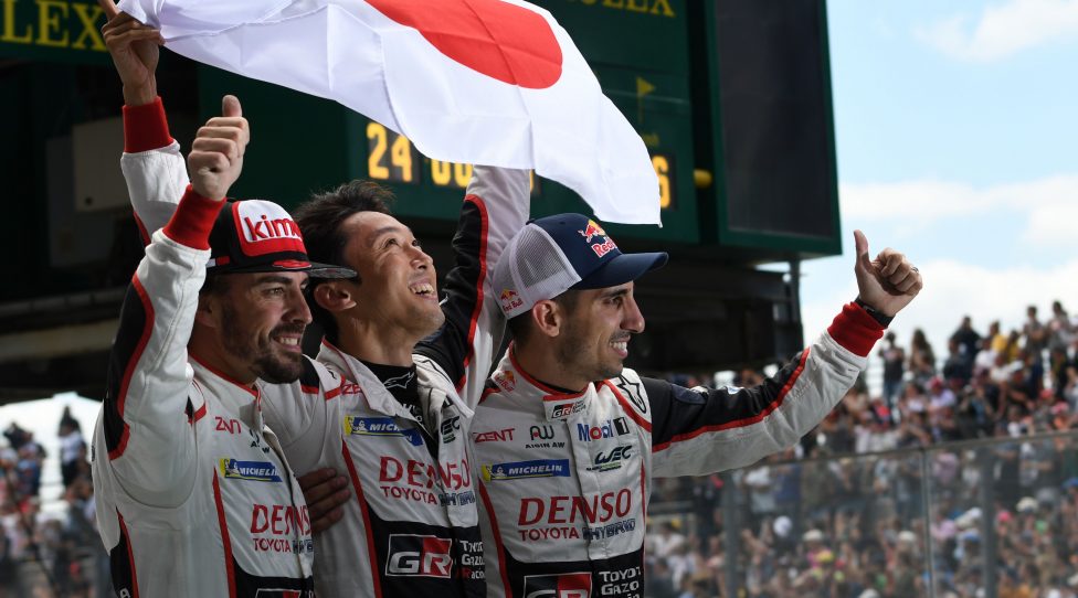 (From L) Spain's driver Fernando Alonso, Japanese's Kazuki Nakajima and Swiss' Sebastien Buemi celebrate (Toyota TS050 Hybrid LMP1 N°8) after winning the 86th Le Mans 24-hours endurance race, at the Circuit de la Sarthe on June 17, 2018 in Le Mans, western France. (Photo by Jean-Francois MONIER / AFP)        (Photo credit should read JEAN-FRANCOIS MONIER/AFP/Getty Images)