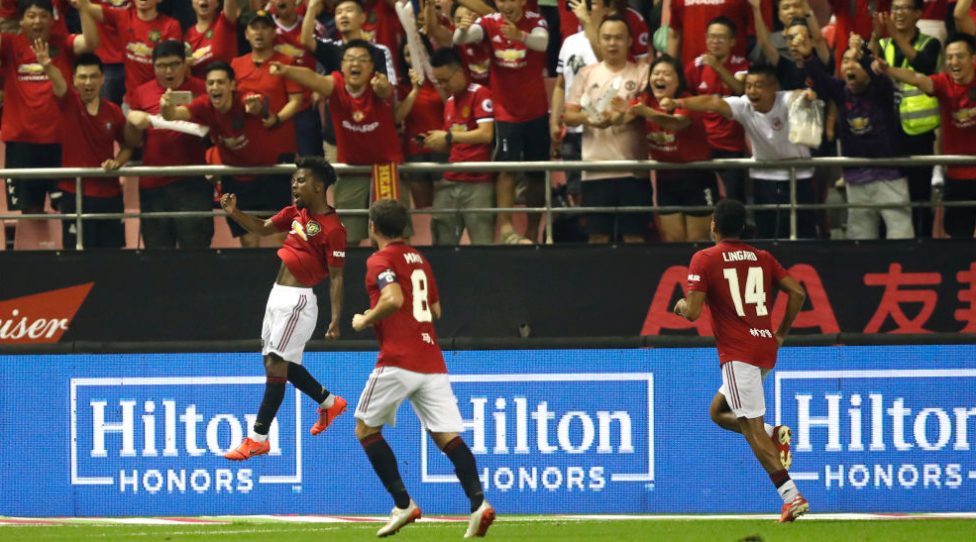 SHANGHAI, CHINA - JULY 25: Angel Gomes (1st L) of Manchester United celebrates scoring his side's second goal during the International Champions Cup match between Tottenham Hotspur and Manchester United at the Shanghai Hongkou Stadium on July 25, 2019 in Shanghai, China. (Photo by Fred Lee/Getty Images )