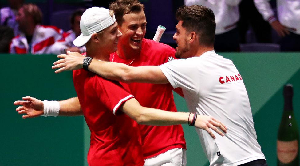 MADRID, SPAIN - NOVEMBER 23: Denis Shapovalov and Vasek Pospisil of Canada celebrate victory with Canada team captain Frank Dancevic in the semi final doubles match between Russia and Canada during Day Six of the 2019 Davis Cup at La Caja Magica on November 23, 2019 in Madrid, Spain. (Photo by Clive Brunskill/Getty Images)