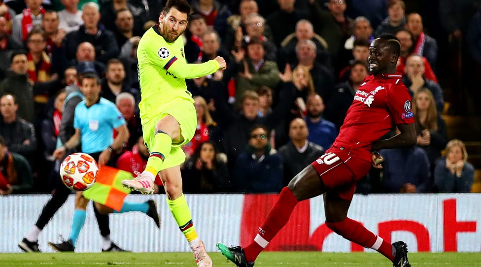 LIVERPOOL, ENGLAND - MAY 07: Lionel Messi of FC Barcelona is challenged by Sadio Mane of Liverpool as he takes a shot during the UEFA Champions League Semi Final second leg match between Liverpool and Barcelona at Anfield on May 07, 2019 in Liverpool, England. (Photo by Chris Brunskill/Fantasista/Getty Images)