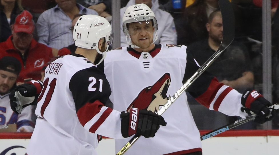 NEWARK, NEW JERSEY - OCTOBER 25: Michael Grabner #40 of the Arizona Coyotes celebrates his shorthanded goal at 2:01 of the second period against Mackenzie Blackwood #29 of the New Jersey Devils as he is joined by Derek Stepan #21 at the Prudential Center on October 25, 2019 in Newark, New Jersey. (Photo by Bruce Bennett/Getty Images)