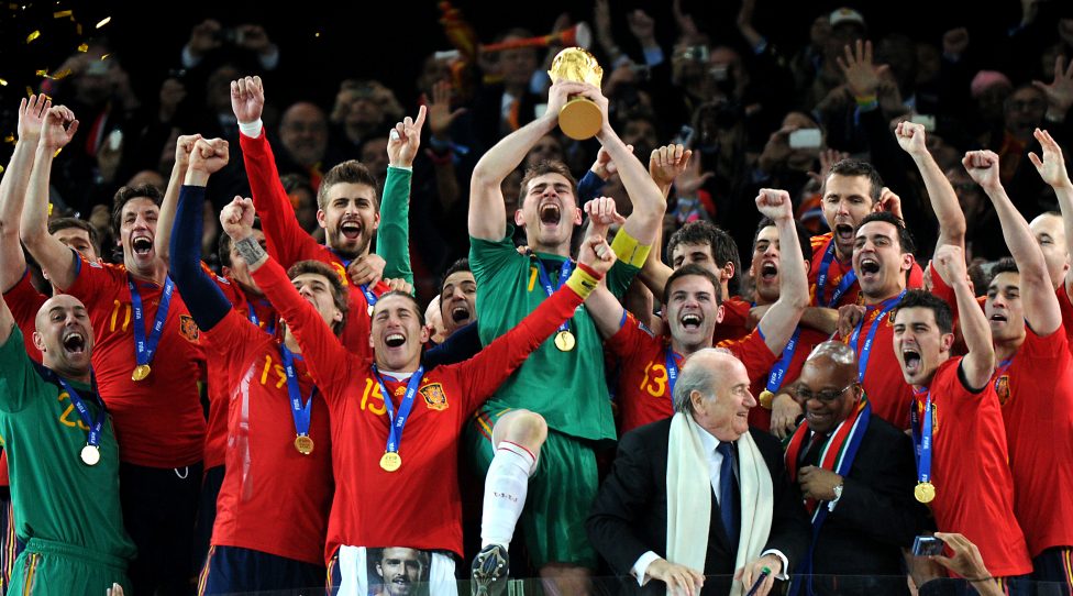 Spain's goalkeeper Iker Casillas (C) raises the trophy handed to him by FIFA President Sepp Blatter (4thR) and South Africa�s President Jacob Zuma (3rdR) as Spain's national football team players celebrate winning the 2010 World Cup football final Netherlands vs. Spain on July 11, 2010 at Soccer City stadium in Soweto, suburban Johannesburg. NO PUSH TO MOBILE / MOBILE USE SOLELY WITHIN EDITORIAL ARTICLE -     AFP PHOTO / GABRIEL BOUYS (Photo credit should read GABRIEL BOUYS/AFP via Getty Images)
