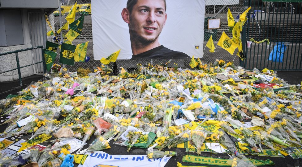 TOPSHOT - Yellow flowers are displayed in front of the portrait of Argentinian forward Emiliano Sala at the Beaujoire stadium in Nantes, on February 8, 2019. - FC Nantes football club announced on February 8, 2019 that it will freeze the #9 jersey as a tribute to Cardiff City and former Nantes footballer Emiliano Sala who died in a plane crash in the English Channel on January 21, 2019. (Photo by LOIC VENANCE / AFP)        (Photo credit should read LOIC VENANCE/AFP via Getty Images)