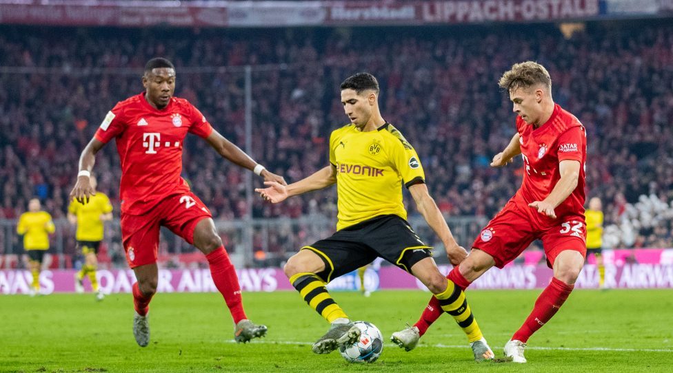 MUNICH, GERMANY - NOVEMBER 09:  Achraf Hakimi of Borussia Dortmund is challenged by Joshua Kimmich of FC Bayern Muenchen during the Bundesliga match between FC Bayern Muenchen and Borussia Dortmund at Allianz Arena on November 09, 2019 in Munich, Germany. (Photo by Boris Streubel/Getty Images)