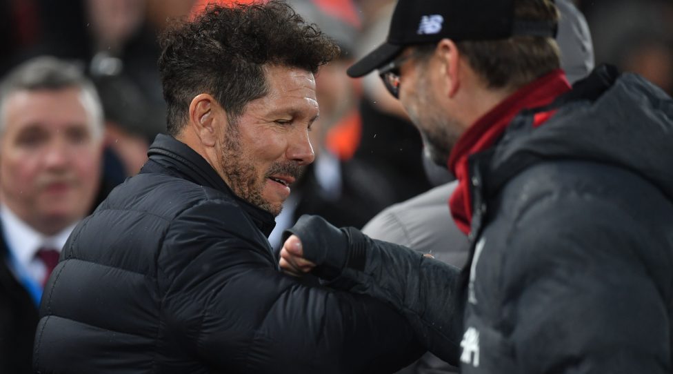 Atletico Madrid's Argentinian coach Diego Simeone (L) and Liverpool's German manager Jurgen Klopp gesture during the UEFA Champions league Round of 16 second leg football match between Liverpool and Atletico Madrid at Anfield in Liverpool, north west England on March 11, 2020. (Photo by Paul ELLIS / AFP) (Photo by PAUL ELLIS/AFP via Getty Images)