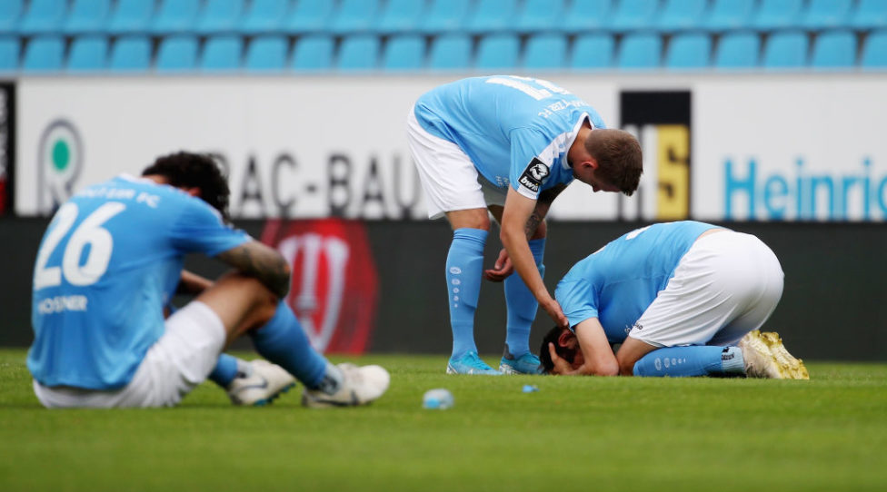 CHEMNITZ, GERMANY - JULY 04:  Philipp Hosiner, Paul Milde and Dejan Bozic of Chemnitz on the ground after the 3. Liga match between Chemnitzer FC and FC Hansa Rostock at Stadion an der Gellertstrasse on July 04, 2020 in Chemnitz, Germany. (Photo by Karina Hessland-Wissel/Getty Images for DFB)