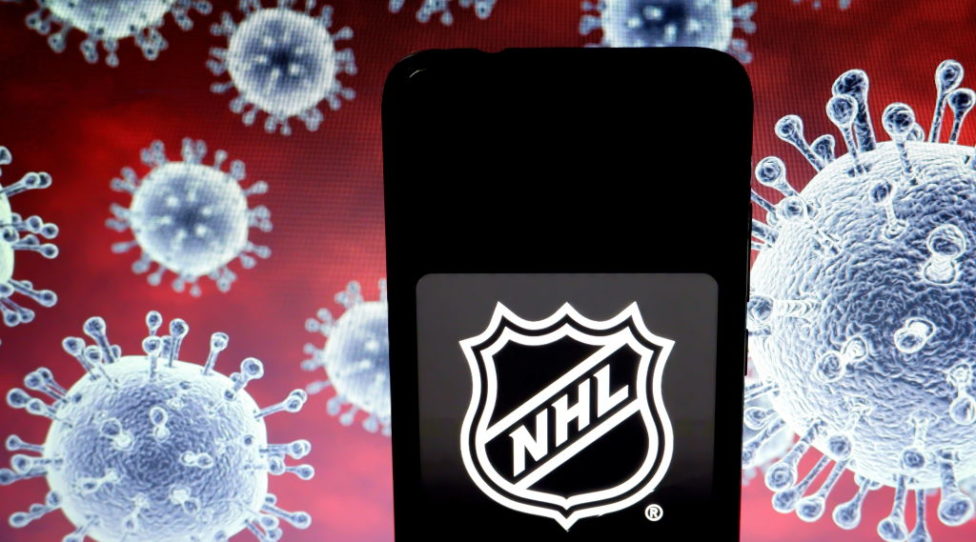 KOLKATA, INDIA - 2020/03/25: In this photo illustration a National Hockey League (NHL) logo seen displayed on a smartphone with a computer model of the COVID-19 coronavirus the background. (Photo Illustration by Avishek Das/SOPA Images/LightRocket via Getty Images)