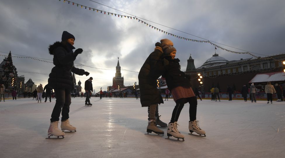 People skate at an outdoor ice skating rink in Red Square in central Moscow on December 2, 2020. (Photo by Natalia KOLESNIKOVA / AFP) (Photo by NATALIA KOLESNIKOVA/AFP via Getty Images)