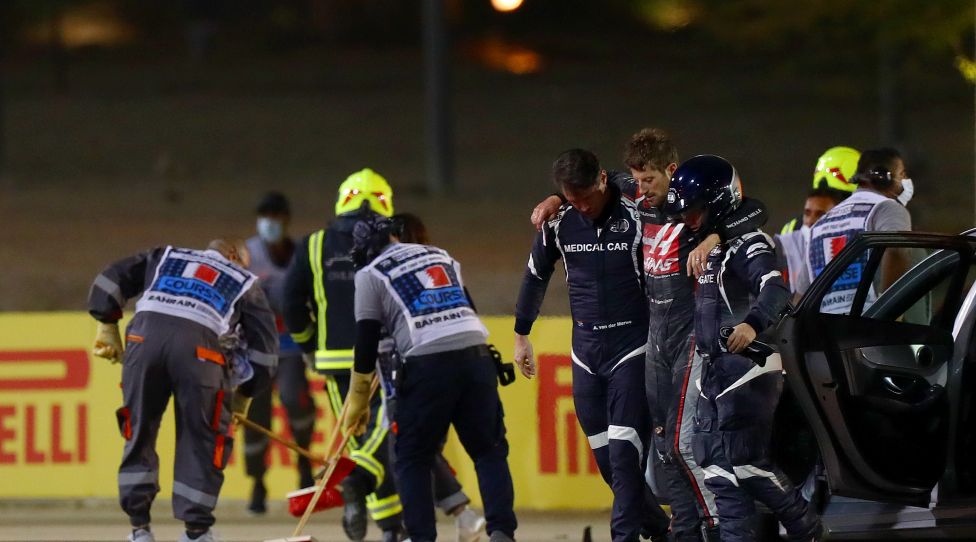 BAHRAIN, BAHRAIN - NOVEMBER 29: Romain Grosjean of France and Haas F1 is pictured being helped from the wreckage after a crash during the F1 Grand Prix of Bahrain at Bahrain International Circuit on November 29, 2020 in Bahrain, Bahrain. (Photo by Dan Istitene - Formula 1/Formula 1 via Getty Images)
