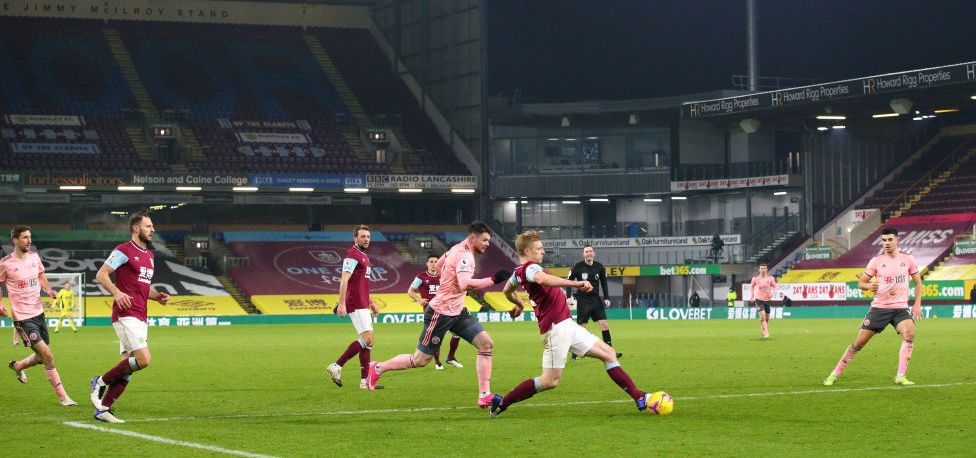 BURNLEY, ENGLAND - DECEMBER 29: General view inside the stadium as Ben Mee of Burnley passes the ball during the Premier League match between Burnley and Sheffield United at Turf Moor on December 29, 2020 in Burnley, England. The match will be played without fans, behind closed doors as a Covid-19 precaution. (Photo by Alex Livesey/Getty Images)
